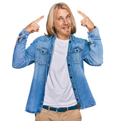 Sticker - Caucasian man with blond long hair wearing casual denim jacket smiling pointing to head with both hands finger, great idea or thought, good memory