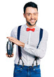 © Krakenimages.com - Hispanic man with beard preparing cocktail mixing drink with shaker winking looking at the camera with sexy expression, cheerful and happy face.