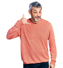 Poster - Middle age hispanic with grey hair wearing casual sweater smiling doing phone gesture with hand and fingers like talking on the telephone. communicating concepts.