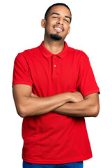 Young african american man wearing casual polo happy face smiling with crossed arms looking at the camera. positive person.