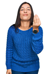 Sticker - Young hispanic woman wearing casual clothes doing italian gesture with hand and fingers confident expression