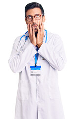 Poster - Young hispanic man wearing doctor uniform and stethoscope tired hands covering face, depression and sadness, upset and irritated for problem