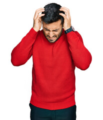 Wall Mural - Young hispanic man wearing casual clothes suffering from headache desperate and stressed because pain and migraine. hands on head.