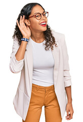 Poster - Young african american girl wearing business clothes smiling with hand over ear listening an hearing to rumor or gossip. deafness concept.