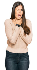 Wall Mural - Young brunette woman wearing casual winter sweater shouting suffocate because painful strangle. health problem. asphyxiate and suicide concept.