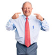© Krakenimages.com - Senior handsome grey-haired man wearing elegant tie and shirt smiling cheerful showing and pointing with fingers teeth and mouth. dental health concept.