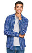 © Krakenimages.com - Young handsome african american man wearing casual clothes looking confident at the camera with smile with crossed arms and hand raised on chin. thinking positive.