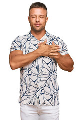 Canvas Print - Handsome muscle man wearing casual clothes smiling with hands on chest with closed eyes and grateful gesture on face. health concept.