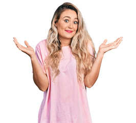 Sticker - Young blonde woman wearing casual pink t shirt clueless and confused with open arms, no idea and doubtful face.