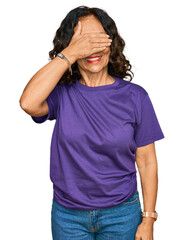 Canvas Print - Middle age hispanic woman wearing casual clothes smiling and laughing with hand on face covering eyes for surprise. blind concept.