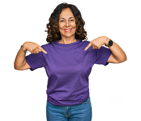 Canvas Print - Middle age hispanic woman wearing casual clothes looking confident with smile on face, pointing oneself with fingers proud and happy.