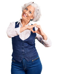 Wall Mural - Senior grey-haired woman wearing casual clothes smiling in love showing heart symbol and shape with hands. romantic concept.