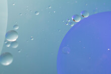 Blue And Aqua Background Of Mid-tones And Small Circles And A Large Sphere Or Planet