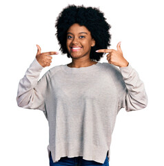 Sticker - Young african american woman wearing casual clothes smiling cheerful showing and pointing with fingers teeth and mouth. dental health concept.