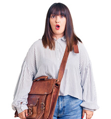 Sticker - Young plus size woman wearing leather bag scared and amazed with open mouth for surprise, disbelief face