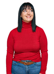 Poster - Young hispanic woman wearing casual clothes looking away to side with smile on face, natural expression. laughing confident.