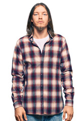 Sticker - Handsome caucasian man with long hair wearing hipster shirt relaxed with serious expression on face. simple and natural looking at the camera.