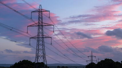 Wall Mural - high voltage pole on silhouette sunset background