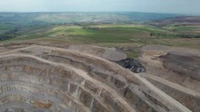 Aerial Drone Forward Moving Shot Of Coldstones Cut Quarry In Harrogate, North Yorkshire, UK Surrounded By Green Grasslands On A Sunny Day.