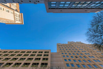 Poster - Residential building exterior with multi level parking lot against blue sky