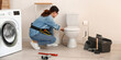 © Pixel-Shot - Female plumber fixing toilet bowl in bathroom