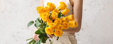 Young Woman With Bouquet Of Beautiful Yellow Roses On Light Background, Closeup