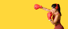 Sporty Female Boxer On Yellow Background With Space For Text