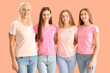 © Pixel-Shot - Beautiful women with pink awareness ribbons hugging on color background. Breast cancer concept