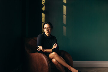 Confident businesswoman sitting in armchair