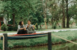 © qunica.com - Couple talking on a red kayak