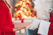 © candy1812 - Hands of Santa Claus giving giftbox to the child.