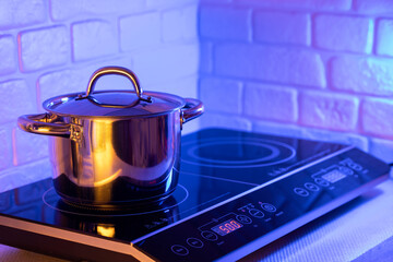 Metal Pot on induction hob in modern kitchen