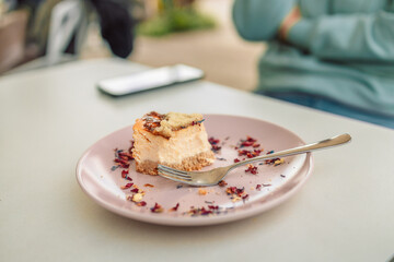 Wall Mural - Eating cheesecake. Sweet dessert cheesecake on a plate in a restaurant. 