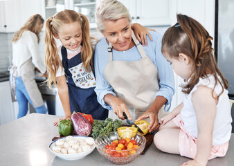 Poster - Grandmother, children and cooking in the kitchen together with vegetables in the family home. Cutting, food and elderly woman in retirement teaching young girl kids to cook meal for lunch or dinner.