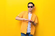 © Sewupari Studio - Excited young handsome Asian man throwing banknotes isolated on yellow background