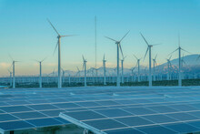 Desert Wind Farm With Solar Panels And Wind Turbines In California