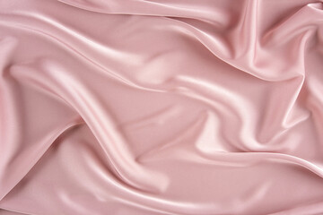 pink silk background. wavy folds pink silk texture satin material. texture of the fabric. pink cloth