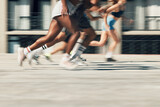 Running, motion and group of people on path together for marathon race, fitness and speed. Fast run team, urban runner club and racing in city street training workout with feet and legs on ground.