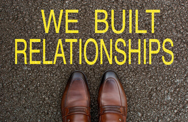 Top View of Business brown Shoes on the road with the text: we  built relationships