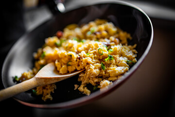 cooking tasty scrambled eggs in frying pan