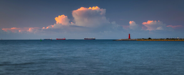 Wall Mural - Bastic Sea in Nowy Port withe the red lighthouse at sunset, Gdansk.