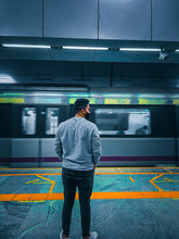 Rear View Of Man Standing On Subway Station