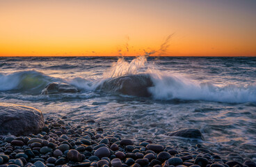 Wall Mural - sea storm with splash from waves on rocky shore