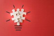 © izzuan - Lightbulb from puzzles on red background with copy space. Inspiration, creative idea concept.