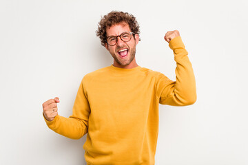 Wall Mural - Young caucasian curly hair man isolated on white background cheering carefree and excited. Victory concept.