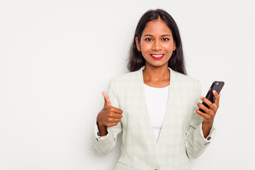 Wall Mural - Young business Indian woman holding a mobile phone isolated on white background smiling and raising thumb up