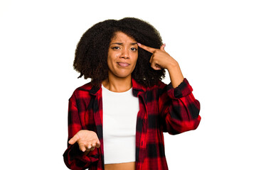 Wall Mural - Young African American woman isolated holding and showing a product on hand.