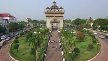 Aerial View Of People And Traffic Around Historic Landmark Victory Gate At Patuxay Park In Vientiane, The Capital And Largest City Of Laos.