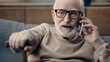 © LIGHTFIELD STUDIOS - bearded senior man in eyeglasses talking on smartphone at home.