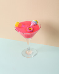 Wall Mural - Creative layout, cocktail glass with neon slime, toy ice cream and donut on two tone pastel background. Visual trend. Minimalistic aesthetic still life. Party concept.